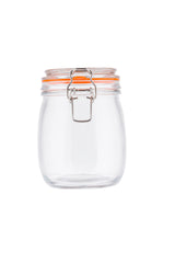 A clear, empty resealable glass canister with a wide mouth, orange rubber seal, and clip-top lid is centered on a white background. The lid is closed, and the canister is clean and transparent with no labels or contents inside.