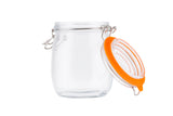 A clear, empty resealable glass canister with a metal clasp and orange rubber seal. Its hinged clip-top lid is open and resting to the side, revealing the circular rim and latch mechanism against a plain white background.