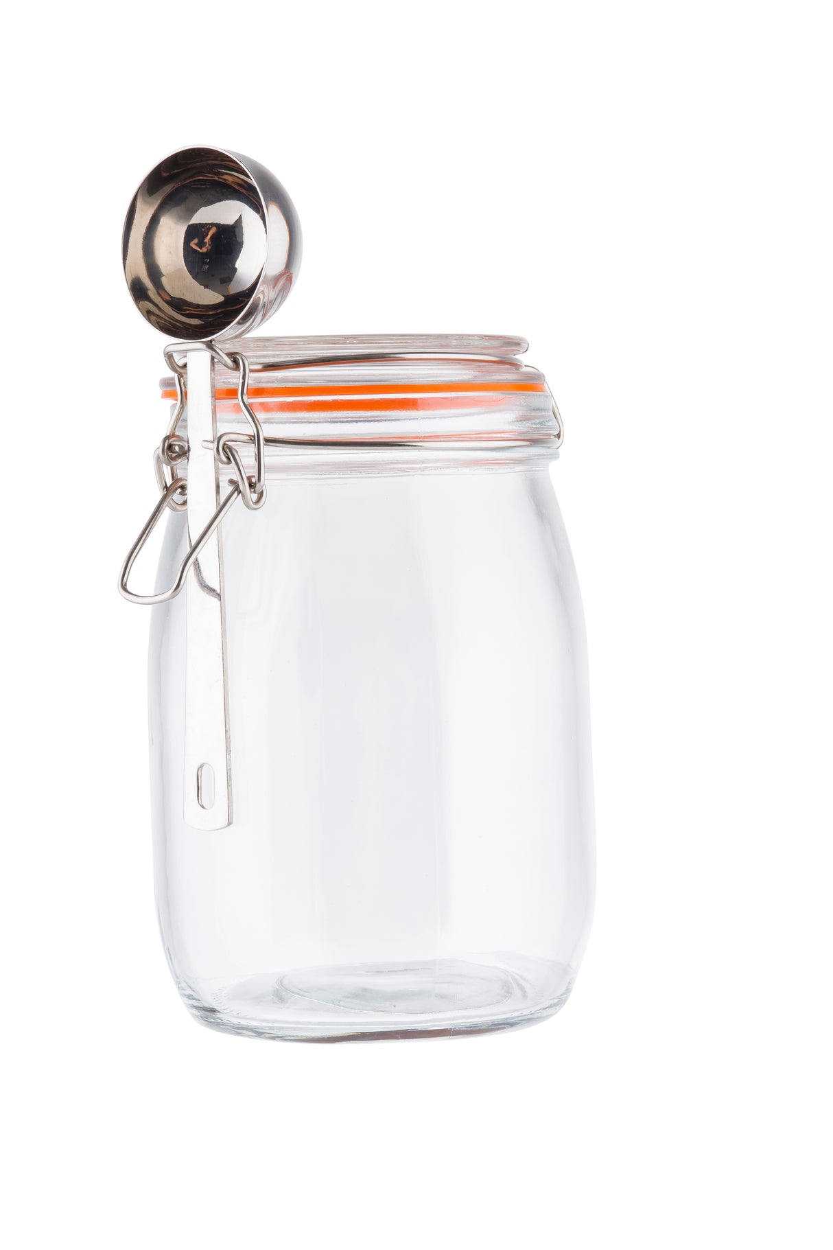 A clear glass canister with an orange rubber seal and metal clip-top lid sits upright. A metal measuring scoop is hooked onto the clasp. The plain white background highlights the canister’s transparency and the scoop’s reflective surface.