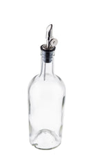 A clear glass bottle with a stainless steel pourer and black rubber stopper stands upright on a white background. This Oil & Vinegar Bottle is empty, with the pour spout angled forward for precise liquid dispensing.