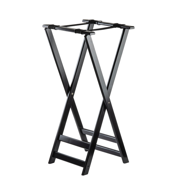 A black folding tray stand with sturdy rubberwood legs crossed in an “X” shape, featuring two flat support straps on top for holding suitcases. The structure is simple, open, and ideal for hotel rooms or guest spaces.