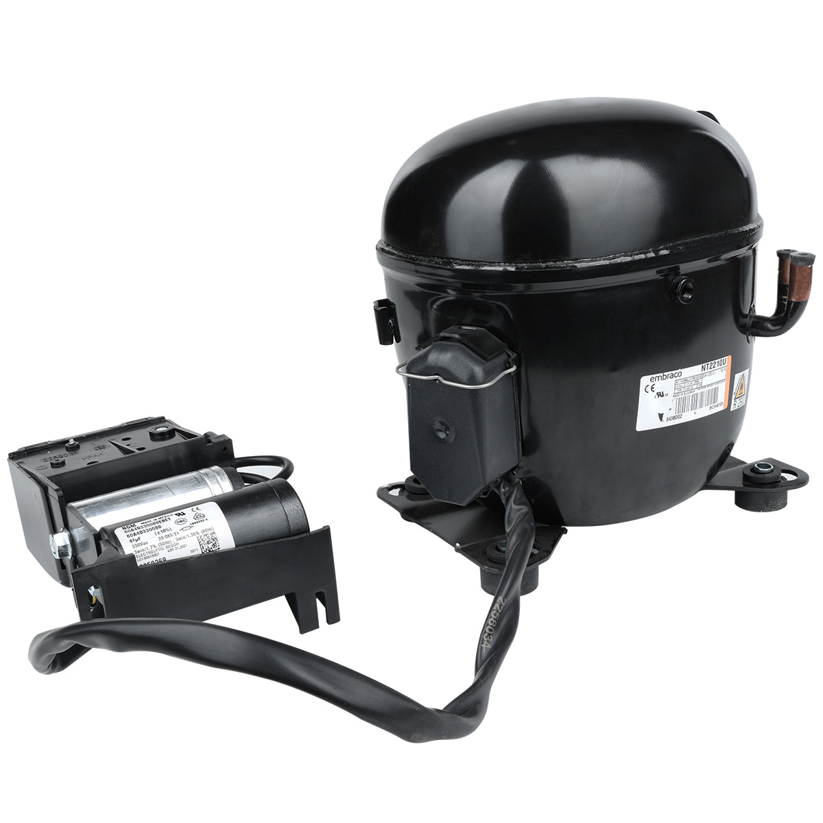 A black Empura Refrigeration compressor with a cylindrical shape is shown connected to an electrical component by a thick black cable. Both parts have labels with text and diagrams. The compressor has metal mounting feet and a copper pipe outlet.