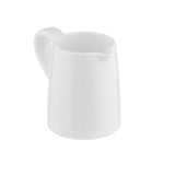 A white ceramic creamer pitcher from the Pulito Collection with a handle and small spout. Subtle horizontal ridges create a textured, modern look. The simple design stands out against a plain white background.