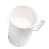A white Sierra Collection Creamer filled with milk, viewed from above. The pitcher has a handle and a small spout, set on a plain white background. The milk reaches close to the top, showing a smooth surface.