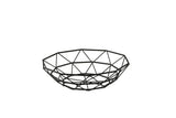 A modern, black TableCraft wire basket fruit bowl with a geometric pattern, crafted from powder coated steel. Its interconnected angular lines form a wide, shallow, circular shape and it sits empty on a white background.