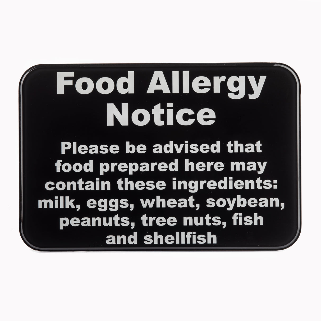 A wall mounted black warning sign with bold white text reads: Food Allergy Notice. Please be advised that food prepared here may contain these allergy ingredients: milk, eggs, wheat, soybean, peanuts, tree nuts, fish, and shellfish.