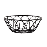 A round metal basket with a black powder coat finish features an open, curved design forming arched patterns. The flat base and widening top create a shallow bowl shape, making this serving basket both modern and minimalist.