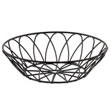 A round, black wire serving basket from the TableCraft Petal Collection features an open, crisscross spiral design. With no handles and a wide, shallow shape, its geometric metal wires offer airy visibility and ventilation for fruit or snacks.