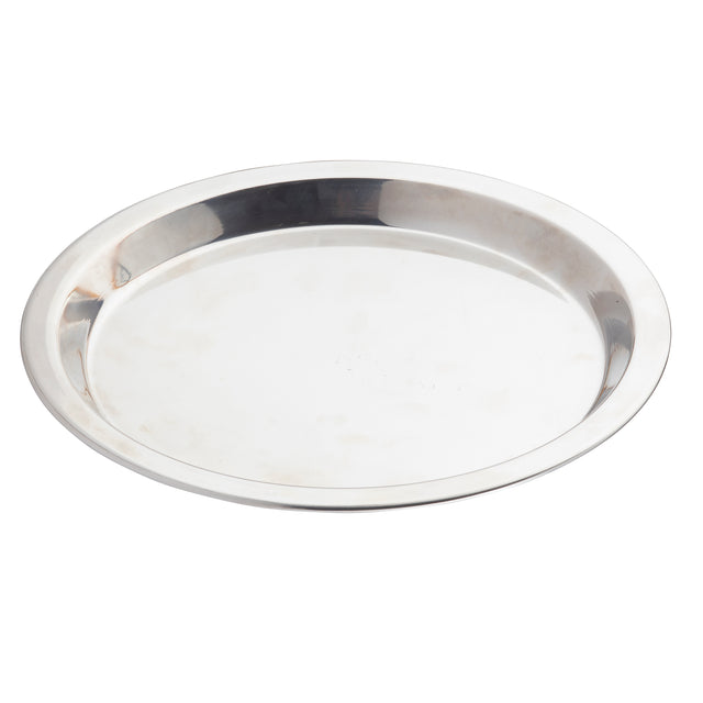 A shiny, round stainless steel pie pan with a slightly raised edge is shown against a white background. The plate’s surface reflects light, displaying faint blotches and marks, giving it a used appearance.