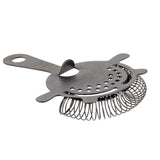 A stainless steel TableCraft strainer featuring a flat handle, circular perforated plate, two stabilizing prongs, and a coiled spring around the edge, designed for straining ice from mixed drinks. The strainer rests on a white background.