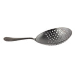 A stainless steel slotted spoon with a textured handle and bowl, featuring numerous round holes for draining liquids. The spoon, resembling a Julep Strainer, is photographed on a white background with the handle to the left.