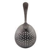 A vintage stainless steel slotted spoon with a wide, slightly oval bowl featuring multiple round holes for draining and a textured, curved handle that tapers at the end. The metal has a dark, matte black acid etch finish. Shown on a white background.