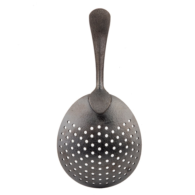 A vintage stainless steel slotted spoon with a wide, slightly oval bowl featuring multiple round holes for draining and a textured, curved handle that tapers at the end. The metal has a dark, matte black acid etch finish. Shown on a white background.