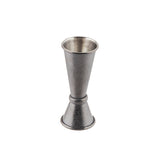 A Japanese Jigger crafted from 18/8 stainless steel features a textured surface and black acid etch finish. Shaped like two connected cones of different sizes, it stands upright against a plain white background.