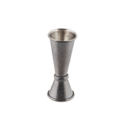 A Japanese Jigger crafted from 18/8 stainless steel features a textured surface and black acid etch finish. Shaped like two connected cones of different sizes, it stands upright against a plain white background.