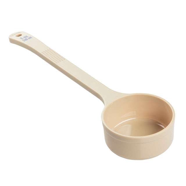 A beige polycarbonate measuring cup with a long handle. The handle features a textured grip and is marked with 3/4 cup and 180 ml in blue text. The empty, clean cup, ideal for Spoonout tasks, is photographed on a white background.