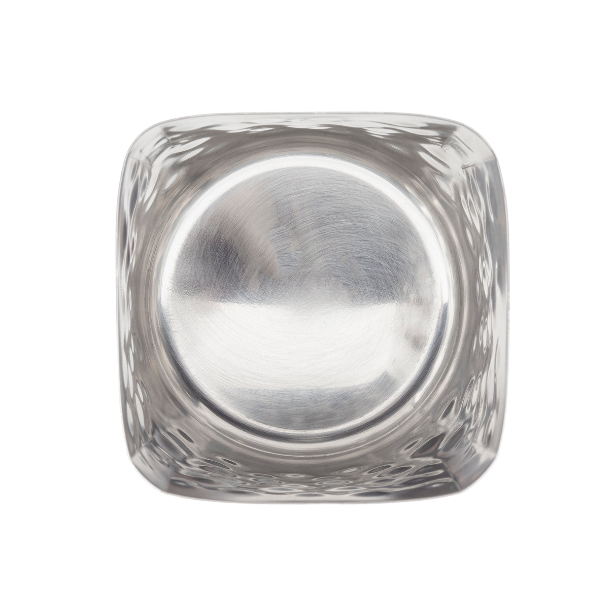 A top-down view of an empty, clear glass tumbler with a square exterior and a round, flat base. The smooth, slightly reflective surfaces echo the clean lines of stainless steel, while the white background highlights its transparency.