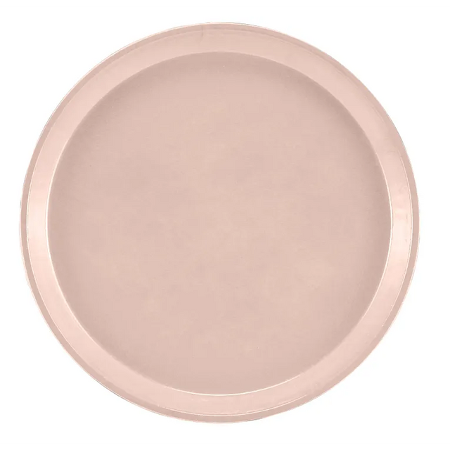 A round, light pink Serving Camtray with a smooth, flat center and a slightly raised rim. Made of durable fiberglass and featuring a matte finish, this NSF-approved tray is ideal for everyday use. The background is plain white.