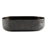 Oval-shaped aluminum oval bowl with a black powder coat, featuring a textured, cracked pattern on its matte exterior. The smooth, rounded edges give this TableCraft bowl a modern and elegant appeal, while the interior remains plain and dark.