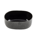 A black aluminum oval bowl with a crackle pattern and powder coat finish. Its rounded edges and mosaic exterior contrast with the smooth, glossy interior, which reflects light beautifully against the plain white background.