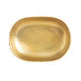 An oval-shaped TableCraft bowl with a gold powder coat finish features a smooth center and a slightly raised, textured rim. Its soft, reflective sheen lends an elegant simplicity, standing out against the plain white background.