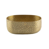 A gold, oval-shaped aluminum bowl with a hammered, pebble-like texture. The TableCraft bowl features smooth edges and a slightly reflective gold powder coat finish, giving it a decorative and elegant appearance.