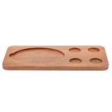 A rectangular acacia wood serving board with a large round groove on the left for a plate and three smaller grooves on the right for cups or bowls. This TableCraft 10709 tray features a smooth, natural finish and rounded edges.