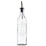 A clear glass Oil Bottle with a stainless steel pourer and black plastic cap, embossed with "QUALITY GLASSWARE EST 1876." The bottle stands empty and upright against a plain white background.
