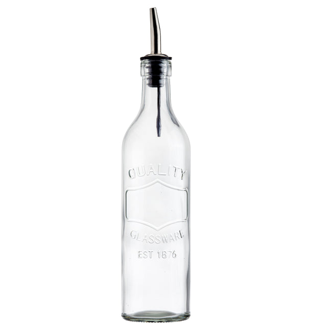 A clear glass Oil Bottle with a stainless steel pourer and black plastic cap, embossed with "QUALITY GLASSWARE EST 1876." The bottle stands empty and upright against a plain white background.