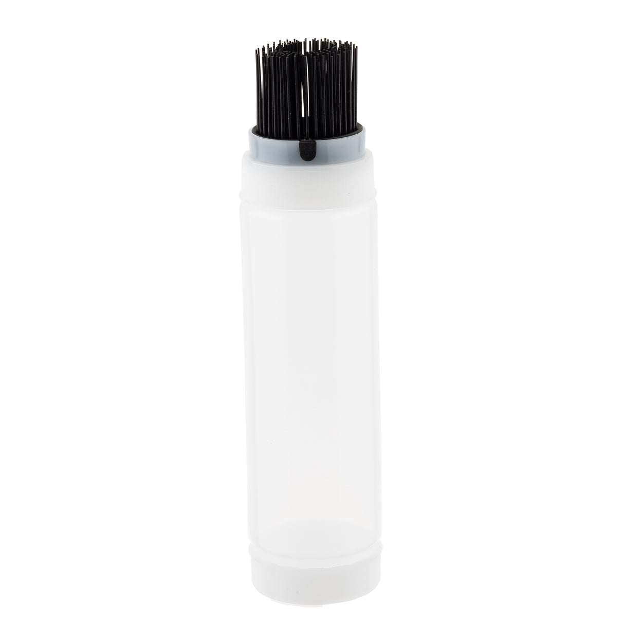 A clear plastic squeeze bottle with a white ValveTop cap stands upright. The cap features an attached bundle of short, black bristles, resembling a built-in brush. The empty squeeze bottle is set against a plain white background.