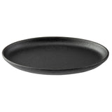 A round, flat, black TableCraft Sizzle Platter with a slightly raised rim, made of matte cast iron, sits empty on a plain white background. Its minimalist, modern design makes it perfect for stylish serving.