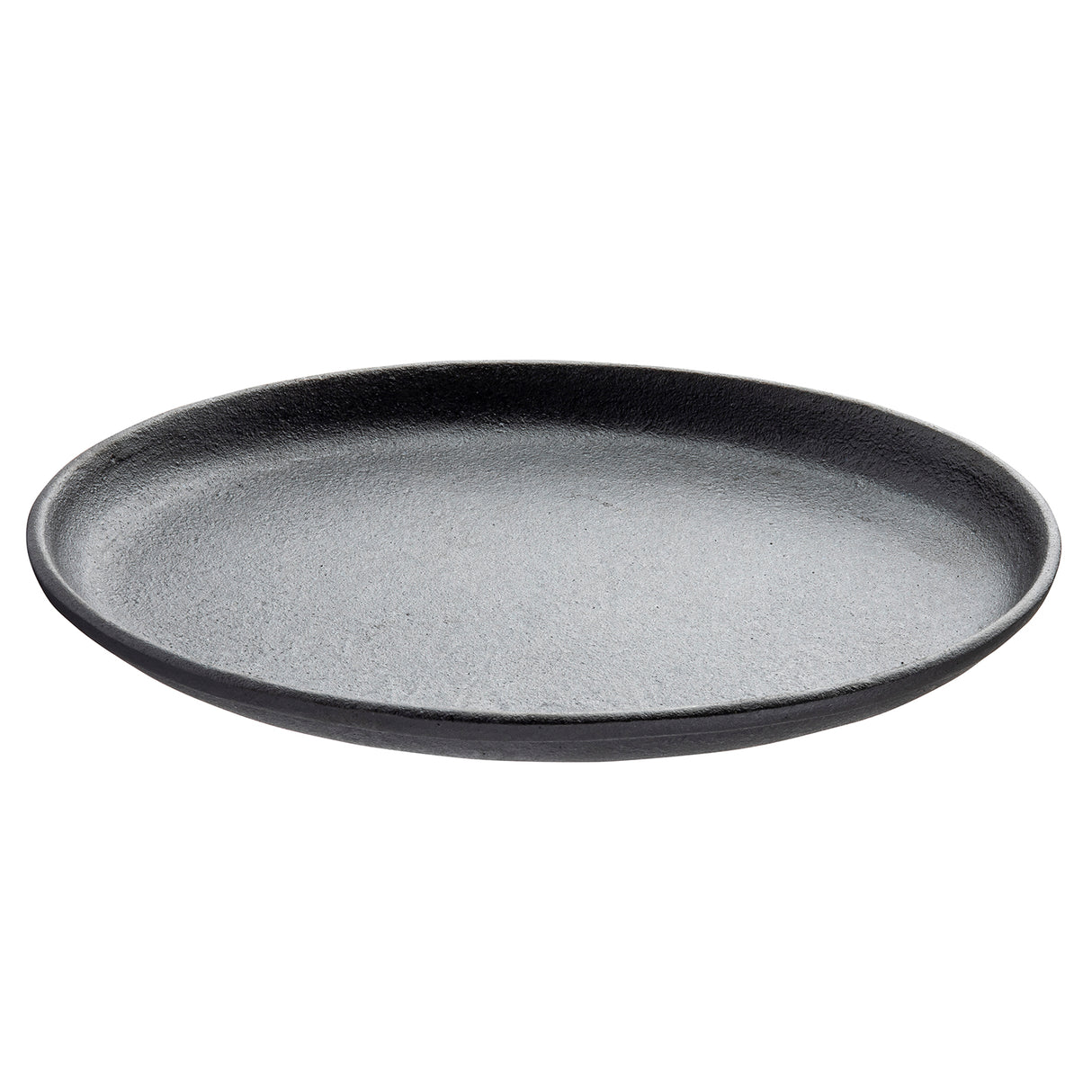 A round, flat, black sizzle platter with a slightly raised edge, made of a matte material that resembles cast iron or stoneware. The TableCraft plate is photographed against a plain white background and is empty.