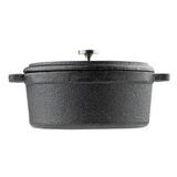 A black, oval-shaped cast iron cocotte with a textured surface, two side handles, and a fitted lid featuring a round metal knob. The photo is taken from the side on a white background.