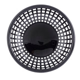 A round, black plastic serving basket is shown from above. With a solid base and grid-like, open-weave sides forming square holes, it features a shiny surface that reflects light. This basket is both heat resistant and dishwasher safe.