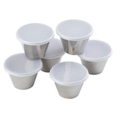Six small stainless steel ramekins with white plastic lids are arranged closely together on a white background. The shiny, cylindrical 3 oz ramekin lids appear to be securely covering each container.