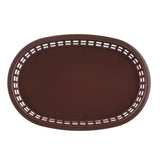 A top-down view of a brown, oval-shaped Chicago Platter Basket with a solid bottom and a rim featuring rectangular cut-out patterns. The surface is smooth, unadorned, and the heat resistant platter basket is empty.