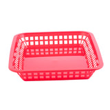 A bright red, square Más Grande Platter Basket with open grid-like sides and a solid base. The basket is empty and placed on a white background, highlighting its shallow depth and simple, functional design. Dishwasher safe and heat resistant.