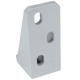 A silver, right-angle Door Hinge Bracket with four oval and circular holes for mounting. This Empura Parts bracket features a smooth finish and is designed for connecting or supporting parts at a 90-degree angle.