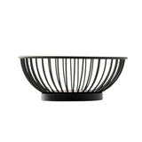 A black, round powder coated steel basket with evenly spaced vertical bars and a solid circular base, photographed against a white background. The empty TableCraft 10820 Parisian Collection Wire Basket has a modern, minimalist design.
