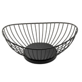 A black wire basket from the Parisian Collection, this oval-shaped fruit holder features an open design with curved metal wires and a solid circular base. Made from powder coated steel, it offers a spacious, modern look on any countertop.