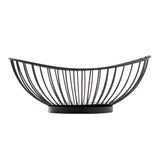 A black wire basket sits on a flat, round base. The semi-circular bowl features evenly spaced vertical bars curving upward and outward, creating an airy and modern design. Part of the Parisian Collection Wire Basket series, it stands out against a plain white background.