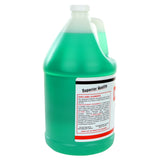 A large clear plastic gallon jug filled with green flatware pre-soak cleaner. The jug has a handle, a white cap, and a label displaying safety and product info, including the words Superior Quality. Ideal for use as a tarnish remover for shine and cleanliness.