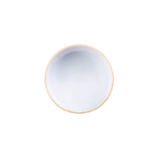 A round, beige-rimmed ceramic bowl filled with a smooth, opaque white liquid sits centered on a plain white background. The bowl is stackable and dishwasher safe, making it as practical as it is elegant.