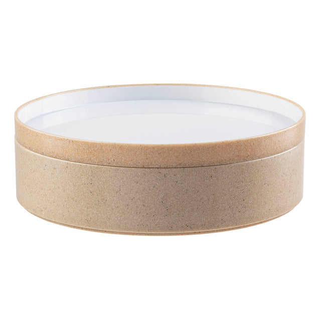 A round, stackable bowl with a cork-textured, light tan base and a smooth, white, flat lid. Its minimalist design stands out against a plain white background.