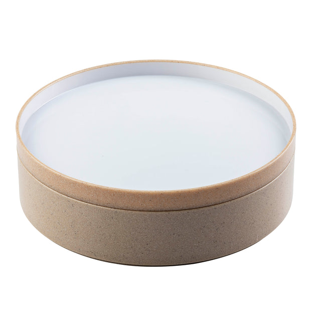 A round, shallow plate with a light brown, speckled base and a smooth, white interior surface. The sides are thick with a slightly raised rim. Simple and modern in design, this stackable plate is perfect for everyday use. Background is plain white.