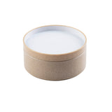 A round, beige bowl with a smooth matte finish and a white, flat lid. The stackable container appears to be made of a natural or eco-friendly material and is photographed against a white background.