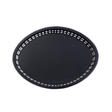 A round, black Texas Platter Basket with a solid center and a pattern of rectangular holes evenly spaced around the rim, shown against a white background. This heat resistant platter has a smooth, matte finish and simple design.