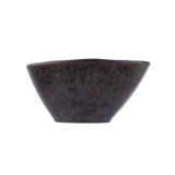 A dark, textured ceramic bowl with slightly flared sides and an uneven rim, featuring a rustic, mottled black and brown stone pattern. The bowl is empty and set against a plain white background.