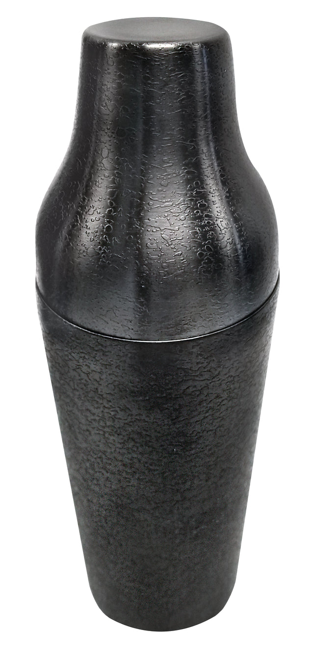 A premium matte black stainless steel cocktail shaker with a textured surface stands upright, cap securely on top. Its modern, sleek design and cylindrical shape are highlighted by lighting against a plain white background.