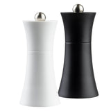 A pair of curved TableCraft salt & pepper mills with brushed metal knobs on top; one is matte white and the other matte black, both standing upright against a white background.